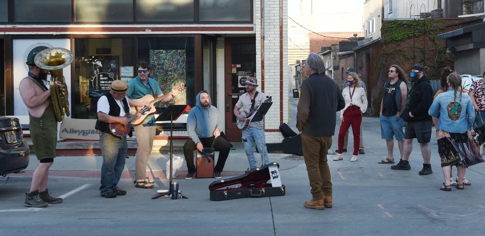 Members of Alleygrass perform in front of KHOI Community Radio during the Music Walk  in downtown Ames Thursday, April 29, 2021, in Ames, Iowa.