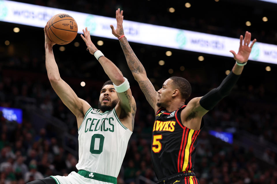 BOSTON, MASSACHUSETTS - APRIL 18: Jayson Tatum #0 of the Boston Celtics takes a shot against Dejounte Murray #5 of the Atlanta Hawks during the fourth quarter of Game Two of the Eastern Conference First Round Playoffs between the Boston Celtics and the Atlanta Hawks at TD Garden on April 18, 2023 in Boston, Massachusetts. The Celtics defeat the Hawks 119-106. NOTE TO USER: User expressly acknowledges and agrees that, by downloading and or using this photograph, User is consenting to the terms and conditions of the Getty Images License Agreement.  (Photo by Maddie Meyer/Getty Images)