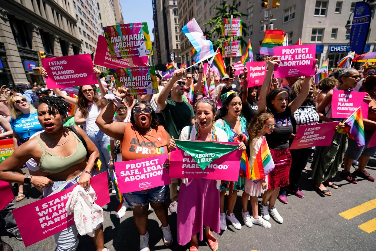 Ana Maria Archila, third from left, a candidate for lieutenant governor, joins revelers with Planned Parenthood as they march down Fifth Avenue during the annual NYC Pride March, Sunday, June 26, 2022, in New York. 