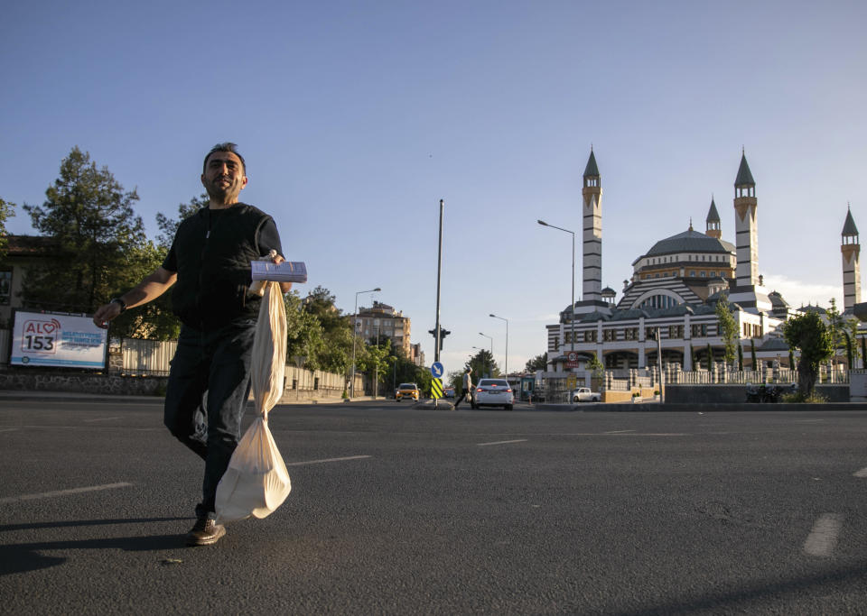 A polling station official carries a bag containing ballots in Diyarbakir, Turkey, early Monday, May 15, 2023. Turkey’s presidential elections appeared to be heading toward a second-round runoff on Monday, with President Recep Tayyip Erdogan, who has ruled his country with a firm grip for 20 years, leading over his chief challenger, but falling short of the votes needed for an outright win. (AP Photo/Metin Yoksu)