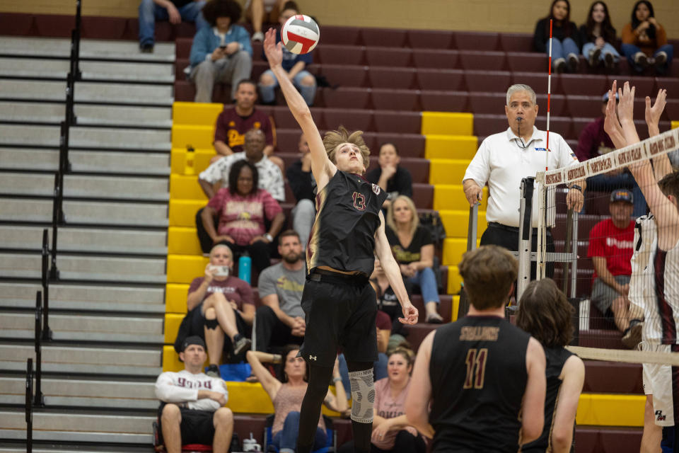 Ryan Louis (13), a senior at Shadow Ridge High School, reaches out for the ball at Shadow Ridge High School gym in Surprise on March 12, 2024.