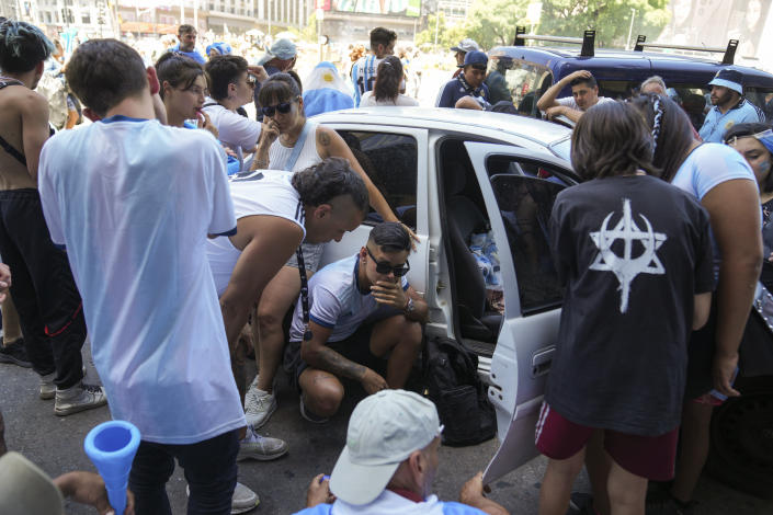 Argentina's fans listen to live commentary on the radio during the World Cup final soccer match between Argentina and France in Buenos Aires, Argentina, Sunday, Dec. 18, 2022. (AP Photo/Matilde Campodonico)