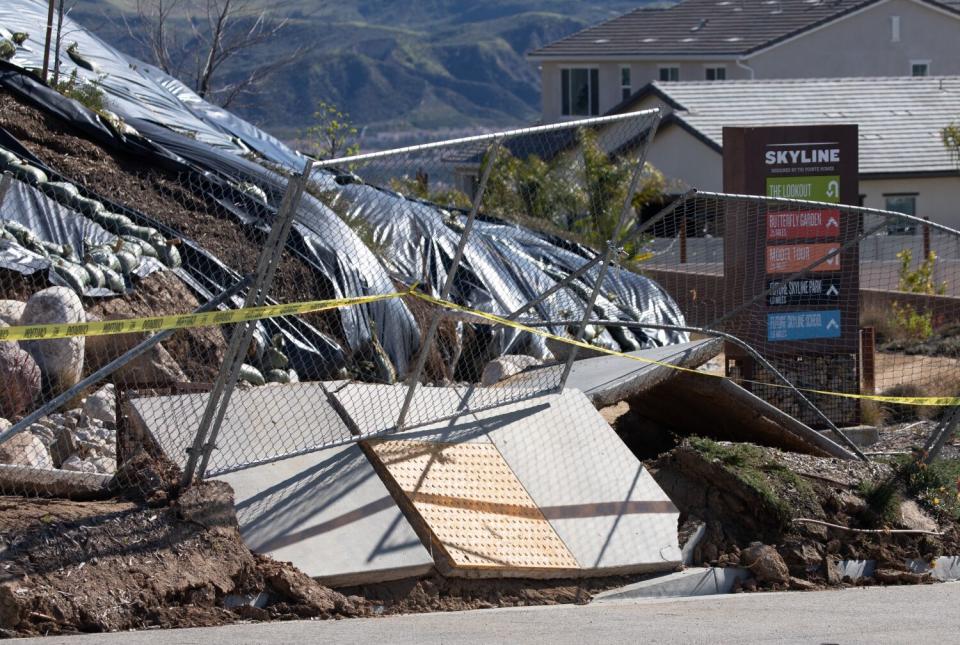 A landslide damaged a sidewalk, pushing it up and away.