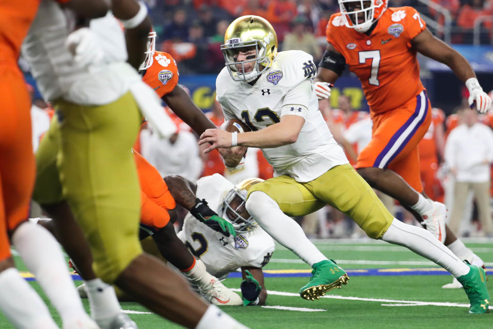 Dec 29, 2018; Arlington, TX, United States; Notre Dame Fighting Irish quarterback Ian Book (12) runs the ball during the first quarter in the 2018 Cotton Bowl college football playoff semifinal game against the Clemson Tigers at AT&T Stadium. Mandatory Credit: Kevin Jairaj-USA TODAY Sports