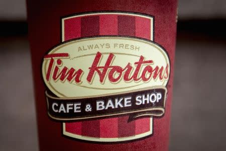 A Tim Hortons coffee cup is seen on the ground outside a shop near Times Square in New York August 26, 2014. REUTERS/Brendan McDermid