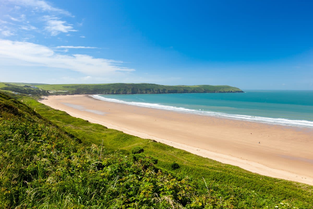 Paddle out on a surf board to enjoy Woolacombe’s waves (Getty Images)