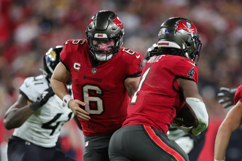 Dec 24, 2023; Tampa, Florida, USA; Tampa Bay Buccaneers quarterback Baker Mayfield (6) hands off to running back Rachaad White (1) against the Jacksonville Jaguars in the third quarter at Raymond James Stadium. Mandatory Credit: Nathan Ray Seebeck-USA TODAY Sports