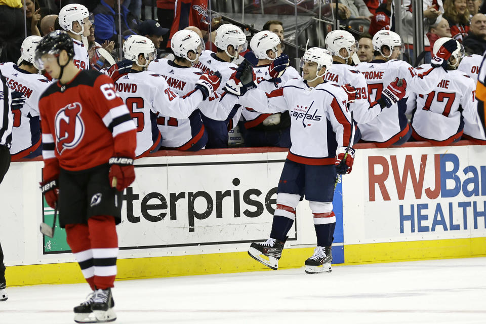 Washington Capitals left wing Conor Sheary (73) celebrates with teammates after scoring a goal in the second period of an NHL hockey game against the New Jersey Devils, Monday, Oct. 24, 2022, in Newark, N.J. (AP Photo/Adam Hunger)