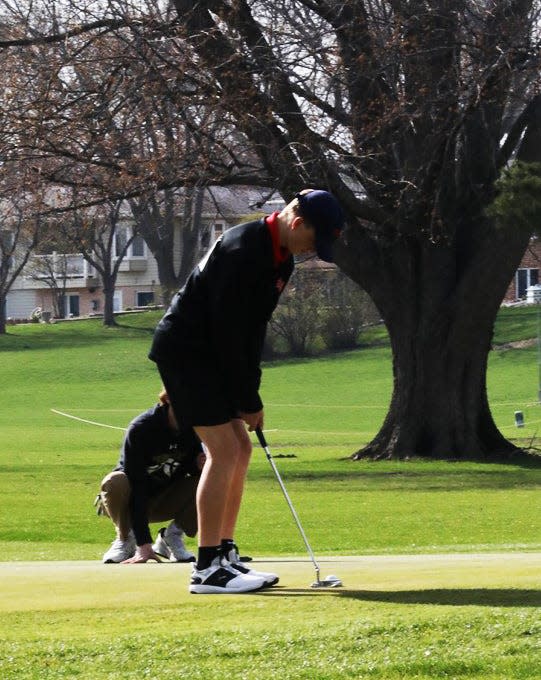 Roland-Story's Nels Hanson putts the ball toward the hole during the Norsemen quadrangular boys golf meet April 18 at the River Bend Golf Course in Story City.