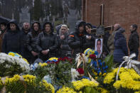 Family and friends attend the funeral of 37-year-old sergeant Kostiv Andrew, who was killed in action, at the Lychakiv cemetery, in Lviv, western Ukraine, Tuesday, April 5, 2022. (AP Photo/Nariman El-Mofty)