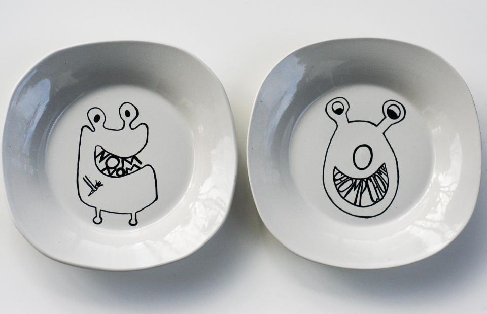 This undated publicity photo provided by The Plumed Nest shows two plates displaying original monster characters created by crafting blogger, Christine Dinsmore, who describes her plate-decorating project on the blog "The Plumed Nest," in Portland, Ore. (AP Photo/The Plumed Nest)