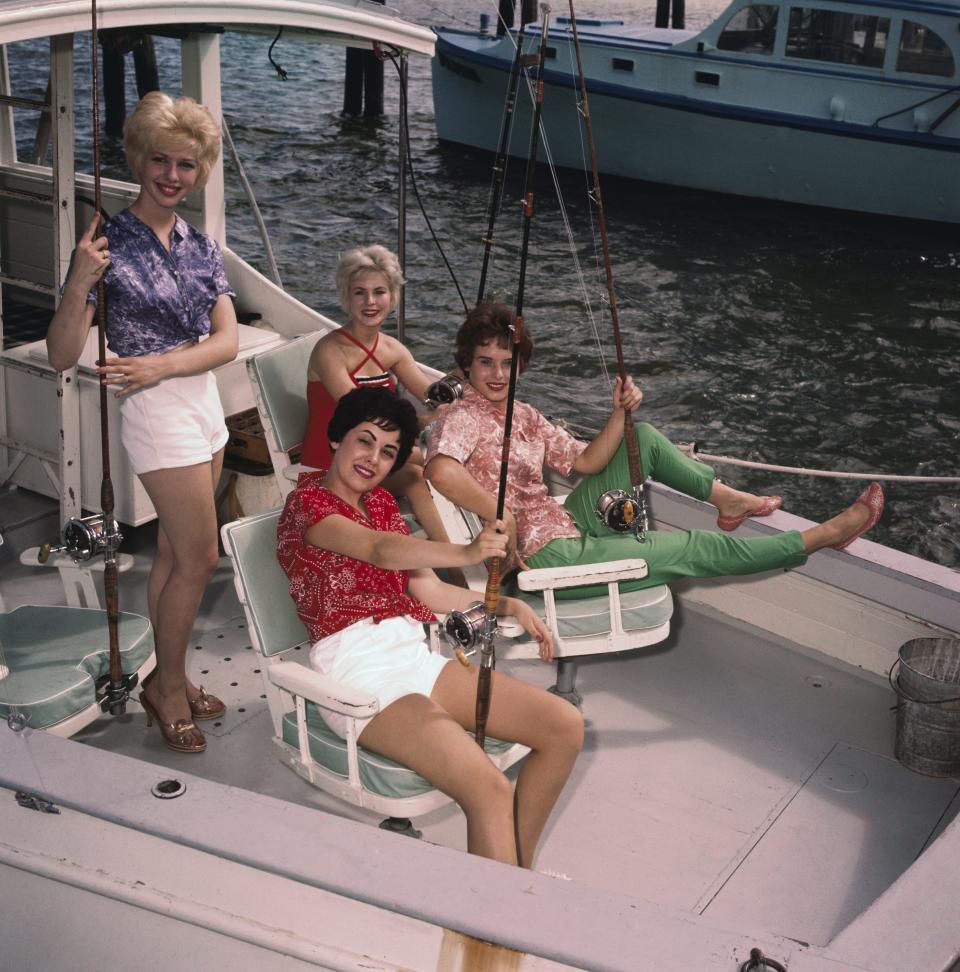 Miami Beach: Four aspirants to the Miss Universe title got the feel of deep sea fishing here during a visit to the Miami beach docks. L to R, Cecilia Claire Upton of Cedartown (Georgia), Patricia Ann Klith of Sioux Falls (South Dakota), June Cochran of Indianapolis, (Indiana), and Svanhildur Jakobsdotti of (Iceland).