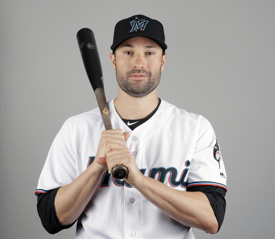 Neil Walker of the Miami Marlins baseball team poses Wednesday, Feb. 20, 2019, in Jupiter, Fla. While Manny Machado agreed to a pending $300 million, 10-year contract with San Diego and Bryce Harper is likely to top Giancarlo Stanton's record $325 million, 13-year deal, many less-than-superstar veterans have been routed on the free-agent market. Walker's salary dropped from $17.2 million to $2 million in two years. (AP Photo/Jeff Roberson)