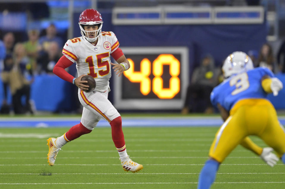 Kansas City Chiefs quarterback Patrick Mahomes, left, runs the ball as Los Angeles Chargers safety Derwin James Jr. defends during the second half of an NFL football game Sunday, Nov. 20, 2022, in Inglewood, Calif. (AP Photo/Jayne Kamin-Oncea)
