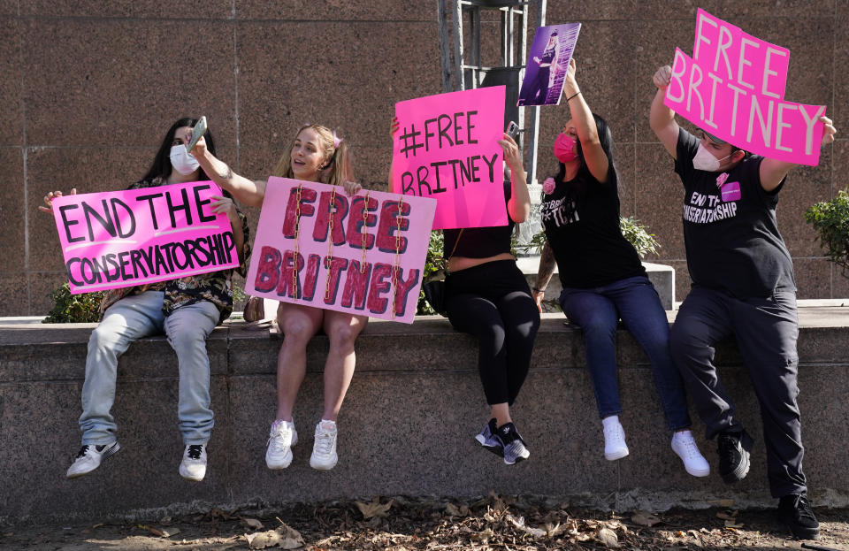 Britney Spears supporters pose together for a photo outside a court hearing concerning the pop singer's conservatorship at the Stanley Mosk Courthouse, Thursday, Feb. 11, 2021, in Los Angeles. (AP Photo/Chris Pizzello)