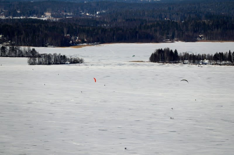 FILE PHOTO: People walk on a frozen lake at the Pajulahti sports center near Lahti