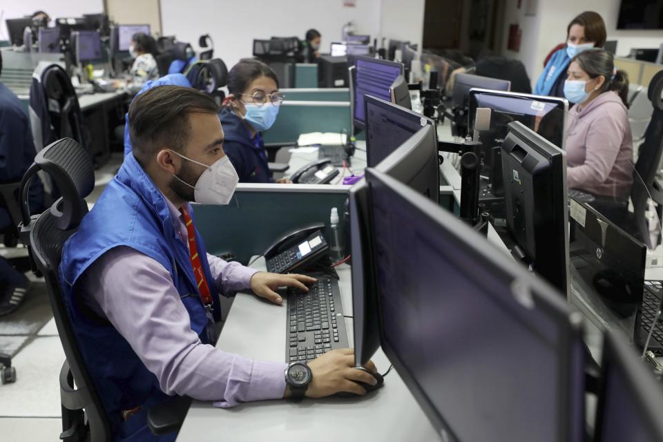 City phone service operators provide psychological support to residents during a nationwide stay-at-home order to prevent the spread of the new coronavirus in Bogota, Colombia, Monday, Aug. 3, 2020. Health experts worry about quarantine fatigue just as cases reach their peak. (AP Photo/Fernando Vergara)