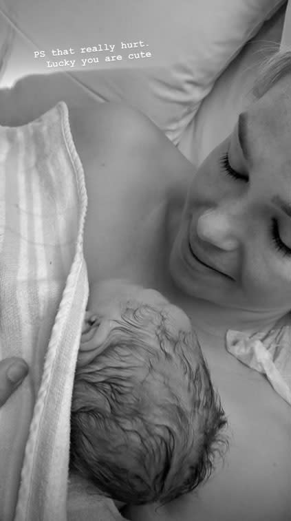 Edwina Bartholomew cradles newborn baby Molly in hospital photo