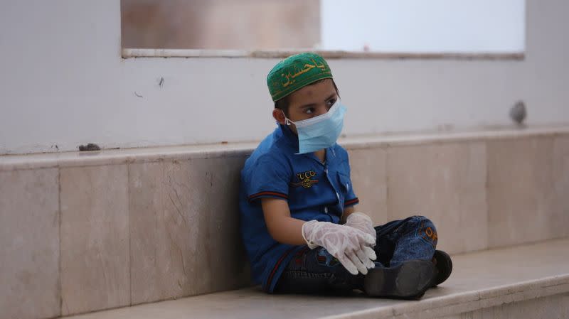 A child who suffers from cancer sits in a corridor at the Children's Hospital for Cancer Diseases in Basra