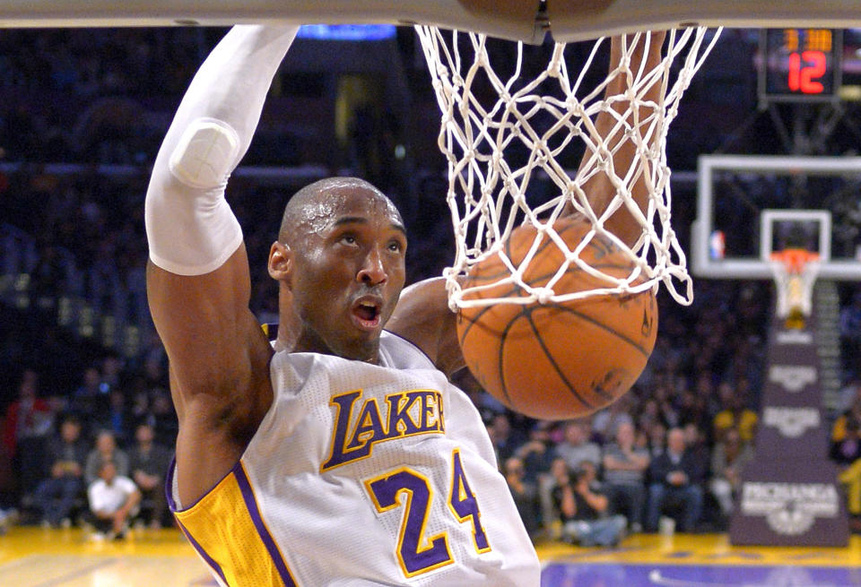 FILE - In this Jan. 4, 2015 file photo Los Angeles Lakers guard Kobe Bryant dunks during the first half of an NBA basketball game against the Indiana Pacers in Los Angeles. Bryant, a five-time NBA champion and a two-time Olympic gold medalist, died in a helicopter crash in California on Sunday, Jan. 26, 2020. He was 41. (AP Photo/Mark J. Terrill)