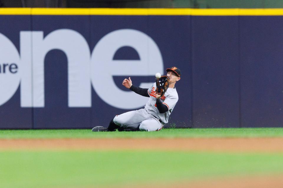 Jun 6, 2023; Milwaukee, Wisconsin, USA; Baltimore Orioles left fielder Austin Hays (21) makes a sliding catch of the fly ball hit by Milwaukee Brewers center fielder Joey Wiemer (28) (not pictured) during the fourth inning at American Family Field.