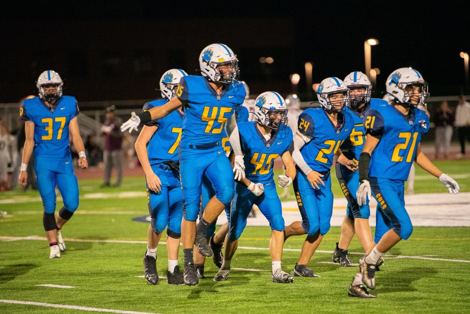 Timnath football players celebrate an interception during a 2022 game. The Cubs got their first win in program history (since the new school opened last fall) with a 25-22 double-overtime victory over The Academy on Friday.