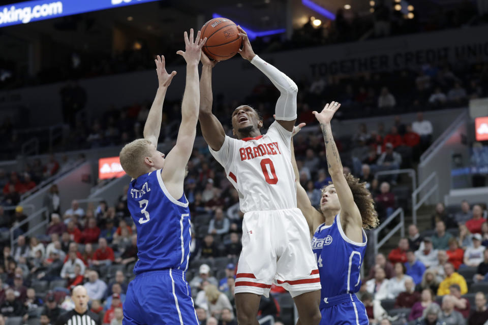 Bradley's Danya Kingsby (0) heads to the basket between Drake's Garrett Sturtz (3) and Noah Thomas during the first half of an NCAA college basketball game in the semifinal round of the Missouri Valley Conference men's tournament Saturday, March 7, 2020, in St. Louis. (AP Photo/Jeff Roberson)