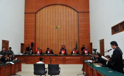 A lawyer (R) is seen stating an objection to the charge of terrorism for Indonesian Muslim militant and suspected Bali bomber Umar Patek (C) during his trial in Jakarta, on February 20. During the first hearing on February 13, prosecutors say they will push for death penalty for Patek, who is facing murder charges for the 2002 Bali bombing and five other counts