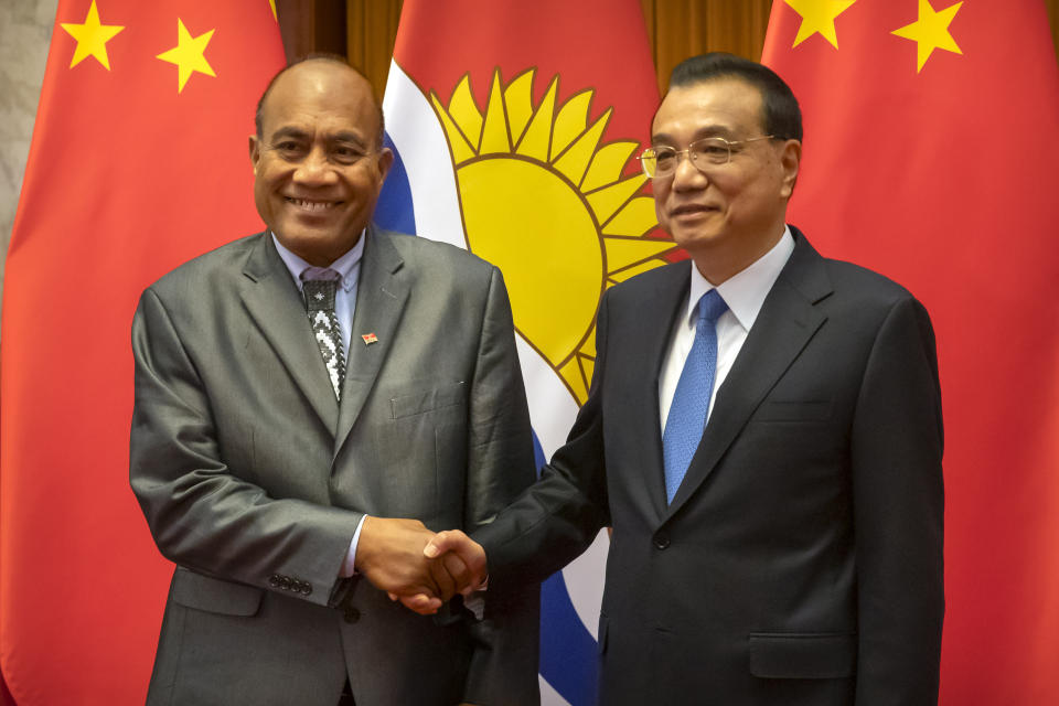 FILE - Kiribati's President Taneti Maamau, left, and Chinese Premier Li Keqiang pose for a photo before a meeting at the Great Hall of the People in Beijing, Monday, Jan. 6, 2020. China wants 10 small Pacific nations to endorse a sweeping agreement covering everything from security to fisheries in what one leader warns is a “game-changing” bid by Beijing to wrest control of the region. (AP Photo/Mark Schiefelbein, Pool, File)