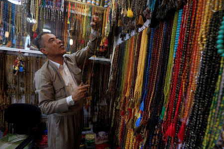 A Kurdish man is seen in a shop at the old city of Erbil, Iraq September 23, 2017. REUTERS/Alaa Al-Marjani