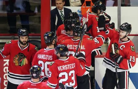 May 18, 2014; Chicago, IL, USA; Chicago Blackhawks center Jonathan Toews (19) celebrates with teammates after defeating the Los Angeles Kings in game one of the Western Conference Final of the 2014 Stanley Cup Playoffs at United Center. Jerry Lai-USA TODAY Sports