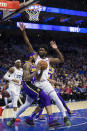 Los Angeles Lakers' Brandon Ingram, left, tries to shoot as Philadelphia 76ers' Joel Embiid, right, of Cameroon, defends the basket during the first half of an NBA basketball game, Sunday, Feb. 10, 2019, in Philadelphia. (AP Photo/Chris Szagola)