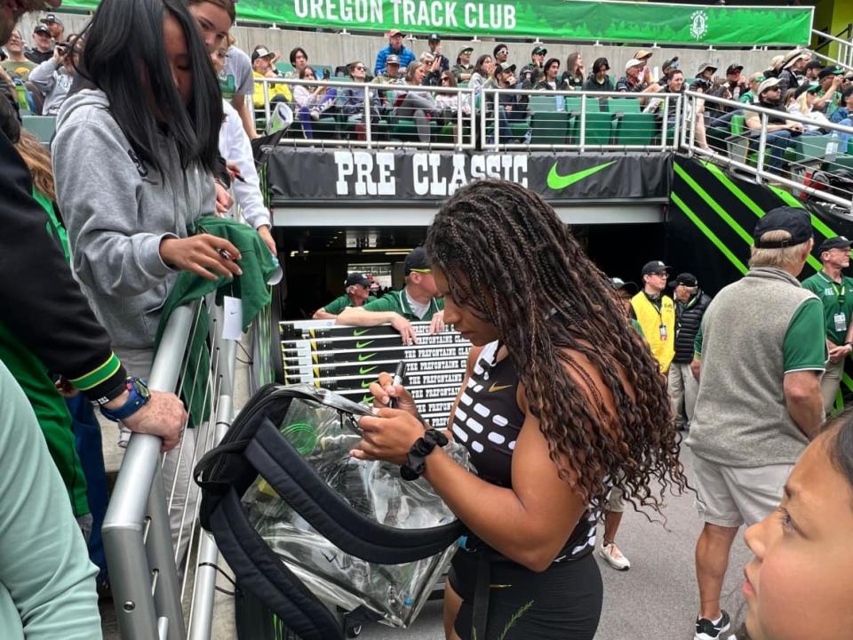 Canadian Camryn Rogers signs an autograph during the Diamond League event Saturday in Eugene, Ore.   (Submitted by Shari Rogers - image credit)