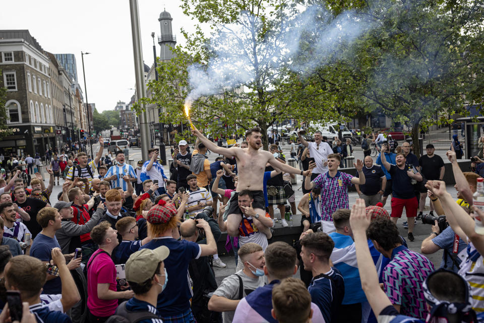 LONDON, ENGLAND - JUNE 17: A Scotland fan lets of a flare outside King's Cross Station on June 17, 2021 in London, England. Officials in Scotland and London, where the match will be hosted at Wembley Stadium, have discouraged Scottish fans without tickets to the game of coming south, due to concerns about the spread of Covid-19. (Photo by Rob Pinney/Getty Images)