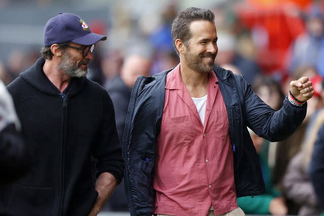 <p>Malcolm Couzens/Getty Images</p> Co-owner of Wrexham Football Club Ryan Reynolds and actor Hugh Jackman meet fans before the Sky Bet League Two match between Wrexham and Milton Keynes Dons