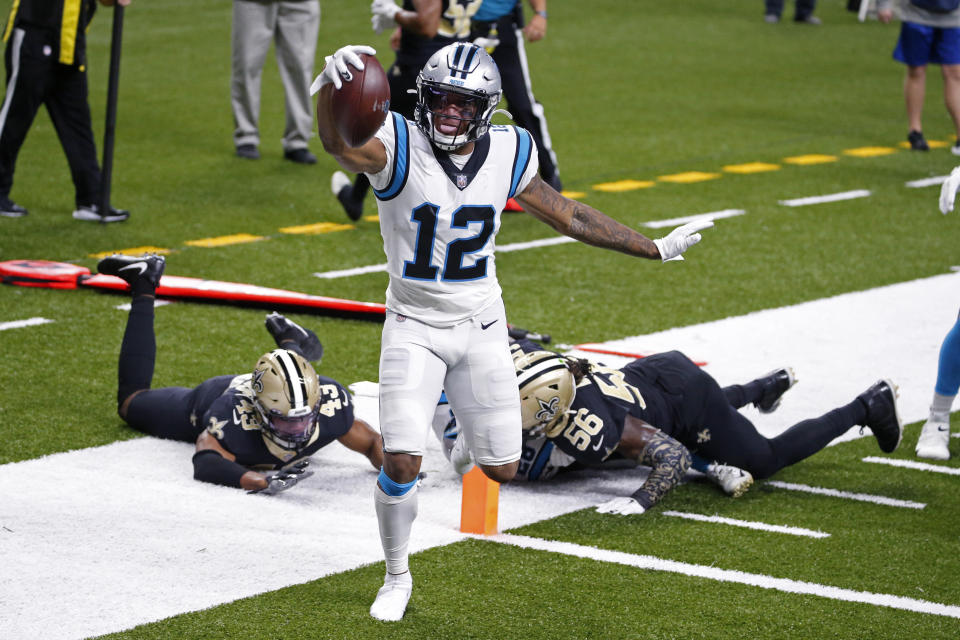 Carolina Panthers wide receiver D.J. Moore (12) crosses the goal line in front of New Orleans Saints free safety Marcus Williams (43) and outside linebacker Demario Davis (56) on a touchdown reception in the first half of an NFL football game in New Orleans, Sunday, Oct. 25, 2020. (AP Photo/Butch Dill)