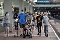 In this Wednesday, June 3, 2020 photo, guests arrive at Universal Orlando Resort Wednesday, June 3, 2020, in Orlando, Fla. The theme park has reopened for season pass holders and will open to the general public on Friday, June 5. (AP Photo/John Raoux)