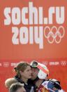 United States' Bode Miller kisses his wife Morgan after his finish in the first run of the men's giant slalom at the Sochi 2014 Winter Olympics, Wednesday, Feb. 19, 2014, in Krasnaya Polyana, Russia.(AP Photo/Gero Breloer)