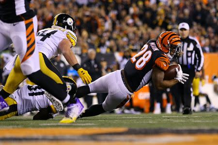 Dec 4, 2017; Cincinnati, OH, USA; Cincinnati Bengals running back Joe Mixon (28) carries the ball against Pittsburgh Steelers outside linebacker Tyler Matakevich (44) in the first half at Paul Brown Stadium. Mandatory Credit: Aaron Doster-USA TODAY Sports