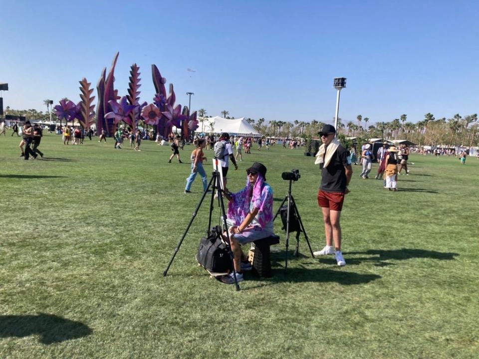 Aaron Hansen works on a painting in the middle of the 2023 Coachella Music and Arts Festival.