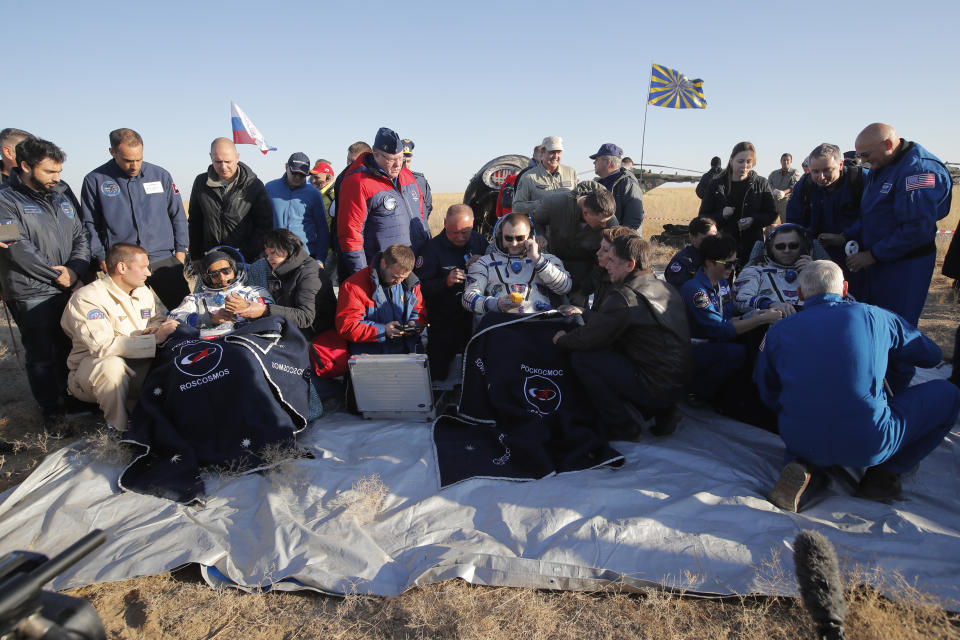 U.S. astronaut Nick Hague, right, Russian cosmonaut Alexey Ovchinin, centre, and United Arab Emirates astronaut Hazzaa Ali Almansoori, sit in chairs shortly after the landing of the Russian Soyuz MS-12 space capsule about 150 km ( 90 miles) south-east of the Kazakh town of Zhezkazgan Kazakhstan, Thursday, Oct. 3, 2019. A Soyuz space capsule with U.S. astronaut Nick Hague, Russian cosmonaut Alexey Ovchinin and United Arab Emirates astronaut Hazzaa Ali Almansoori, returning from a mission to the International Space Station landed safely on Thursday on the steppes of Kazakhstan. (AP Photo/Dmitri Lovetsky, Pool)