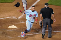 Minnesota Twins' Eddie Rosario tosses his helmet as he scores the winning run on a Max Kepler hit off Detroit Tigers' Bryan Garcia during the 10th inning of a baseball game Tuesday, Sept. 22, 2020, in Minneapolis. The Twins won 5-4. (AP Photo/Jim Mone)