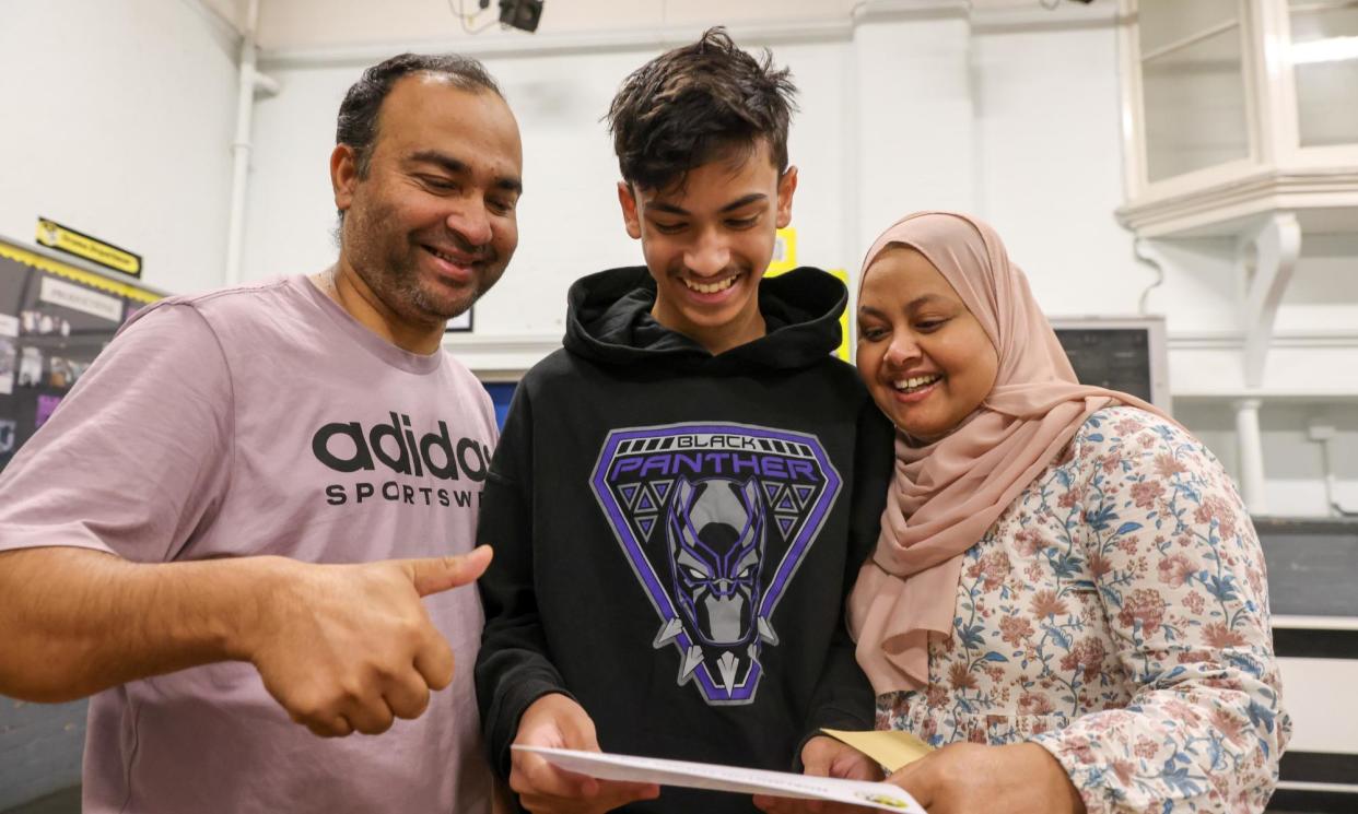 <span>Tahir Qayyum and his parents react to the GCSE results at Norlington school in Waltham Forest, east London.</span><span>Photograph: Dinendra Haria/LNP</span>