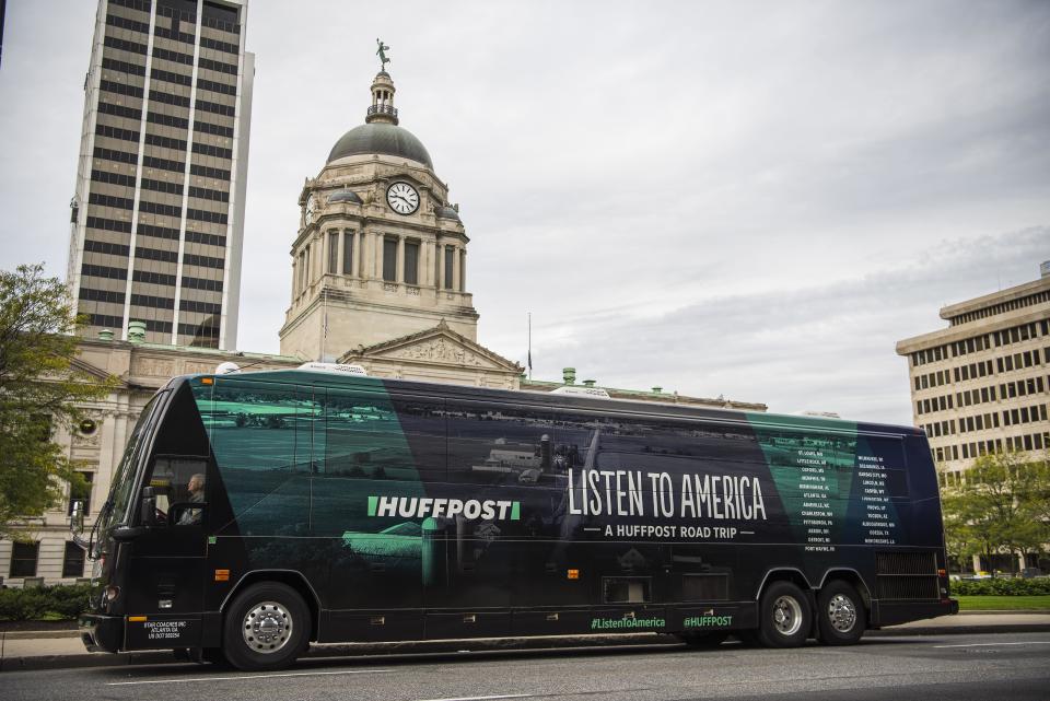 The HuffPost tour bus sits in front of the Allen County Courthouse&nbsp;in Fort Wayne, Indiana, on Oct. 5, 2017, as part of "Listen To America: A HuffPost Road Trip." The news outlet will visit more than 20 cities on its journey&nbsp;across the country.