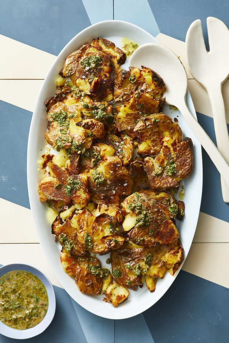 crispy smashed potatoes with caper gremolata on a white plate