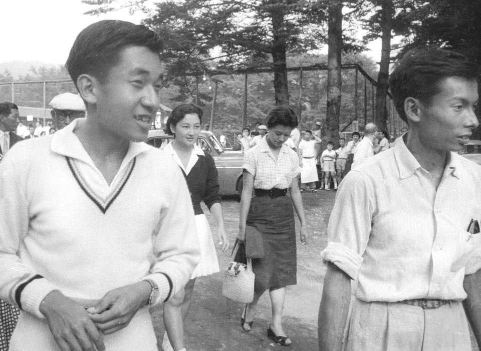 In this August 1958, photo, then Crown Prince Akihito, left, walks with Michiko Shoda, second from left, who married Akihito later, and Akihito's friend Kazuo Oda, right, at a tennis court in Karuizawa, northwest of Tokyo. At his advanced age, Akihito no longer plays tennis as often as he used to. He last played with Oda two years ago. Emperor Akihito has devoted his 30-year reign to making amends for a war fought in his father’s name, while adapting the 1,500-year-old monarchy to draw the Imperial Family closer to the public. (Kyodo News via AP)