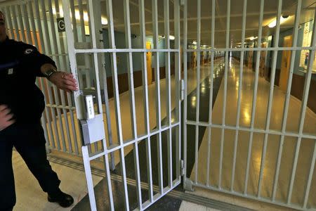 A warder closes the gate inside the men's building at the Fleury-Merogis prison, near Paris, in this May 14, 2014 file picture. REUTERS/Charles Platiau