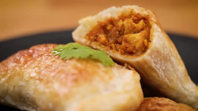 Close up of prata curry puff with chicken and potatoes