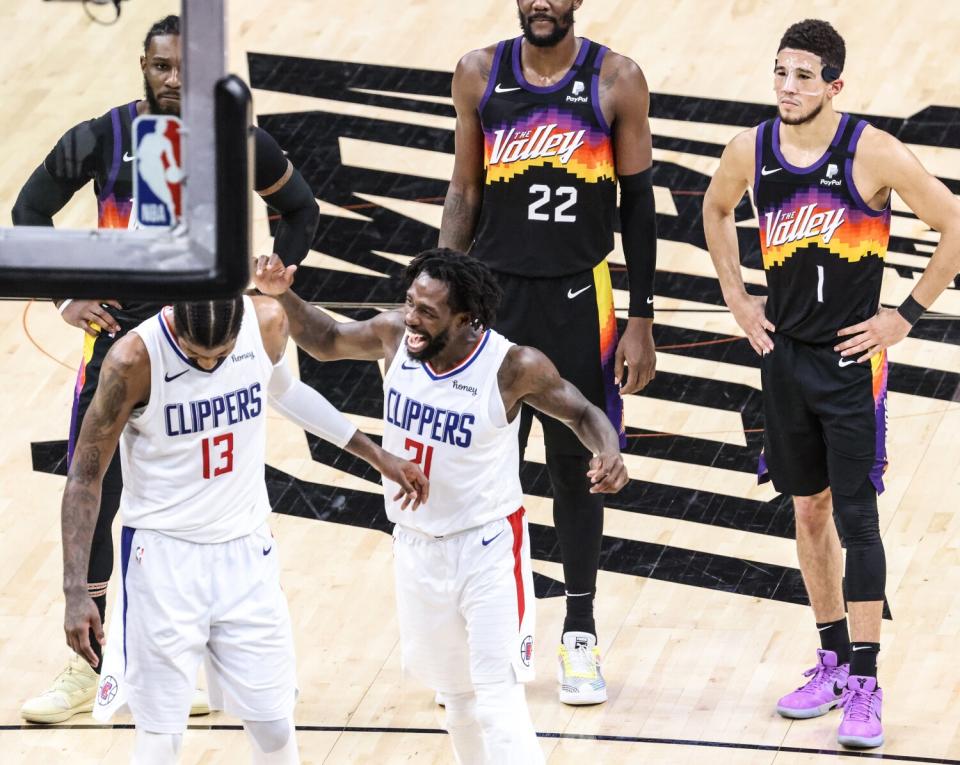 Then-Clippers teammate Patrick Beverley jokes with Paul George before he attempts a technical free throw.