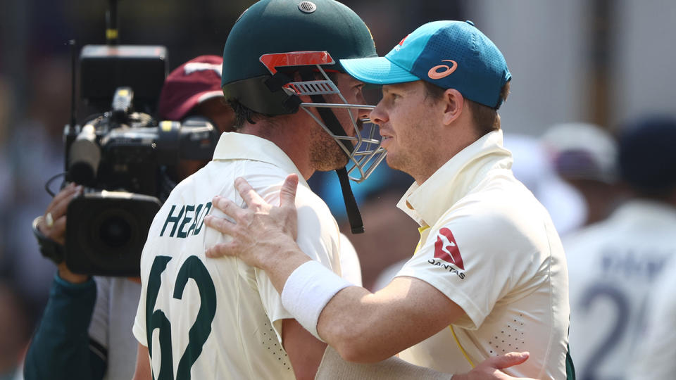 Travis Head is congratulated by Steve Smith.